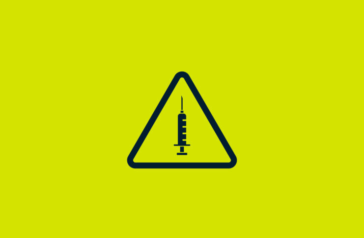 A warning sign with a syringe in the middle.